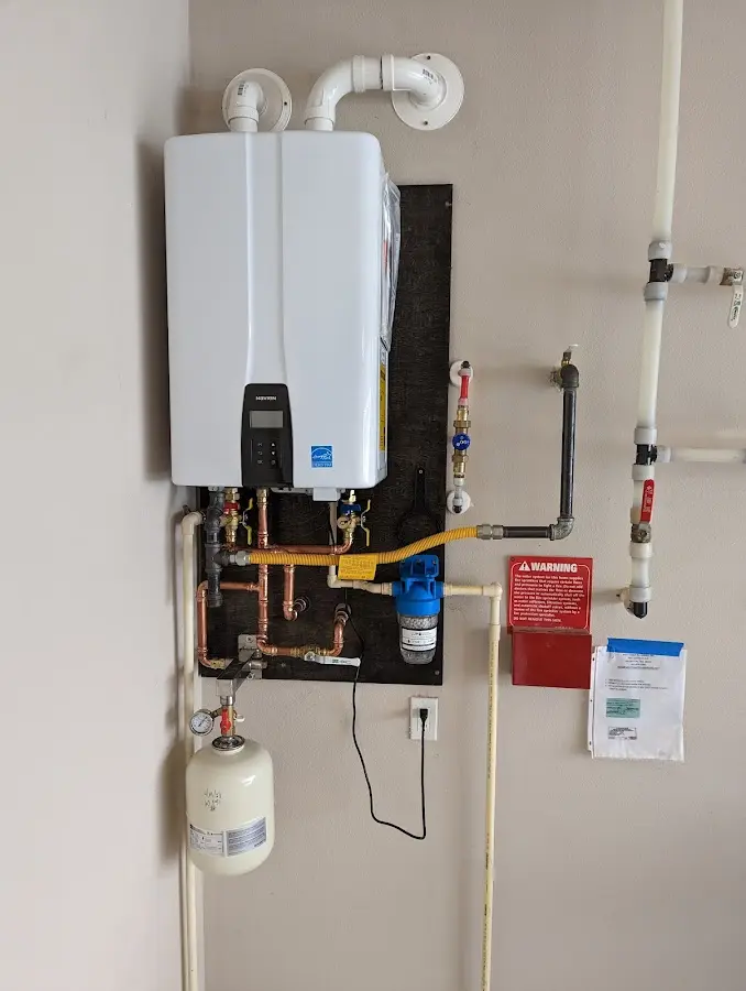 Professional plumber installing copper piping in a Athens home